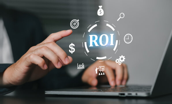 A businessman interacts with a laptop displaying digital icons. ROI Return on Investment, related to business strategy, marketing, data analysis, and financial growth, symbolizing return on investment