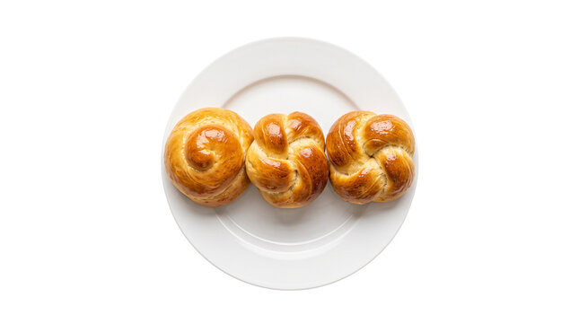 Golden braided brioche buns on white ceramic plate, fresh baked yeast bread rolls, traditional sweet pastry for breakfast isolated PNG with Transparent Background