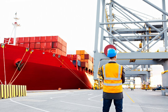 Back, man and inspector at port for logistics, inspection and tracking cargo for distribution. Thinking, person and supervisor at shipyard for observation, quality control and compliance of delivery