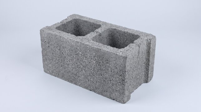 Single grey concrete cinder block isolated on white background