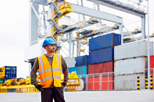 Man, worker and freight with thinking on dock, service or international courier with helmet and vision. Male person, employee and professional mindset by shipping container, logistics port and export