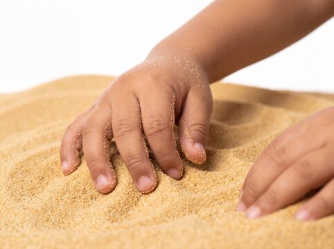Macro Detail of Hispanic Toddler Sifting Desert Sand on White Background