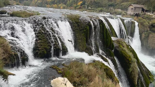 Cinematic close up pan right shot showcasing the powerful cascading water at Strbacki buk waterfall