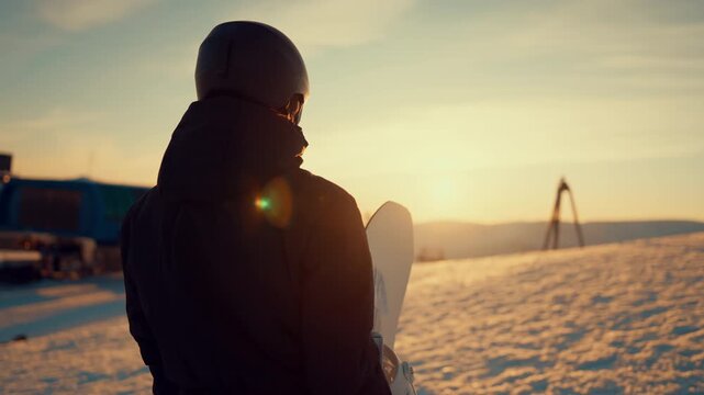 Explore new location, traveling in mountains, woman on slope in ski resort. Inspiring by beautiful nature in highlands in winter, mounts top covered by white snow, back view of lady admiring sunset