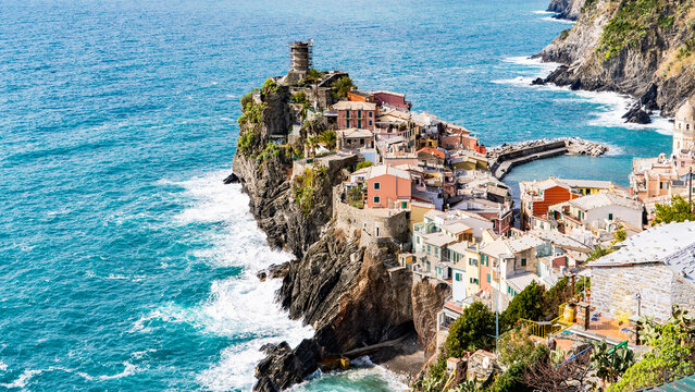 Colorful coastal village perched on a dramatic cliffside in Italy