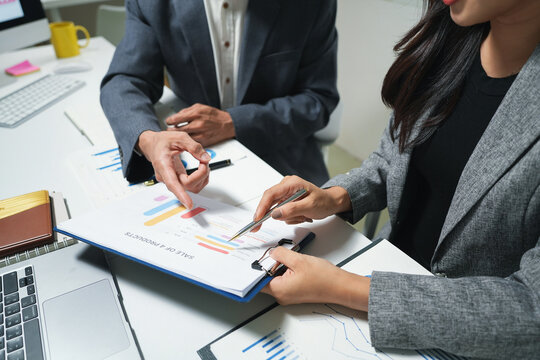 Business Team Reviewing Financial Charts in Office