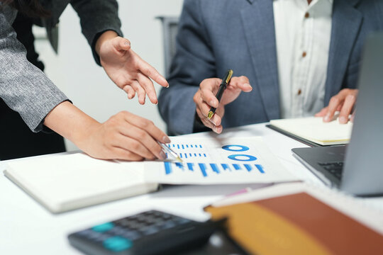 Business Team Analyzing Financial Charts in Meeting