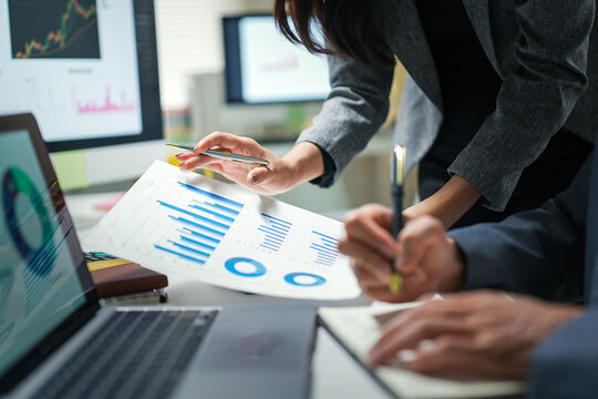 Business Team Reviewing Financial Charts in Office