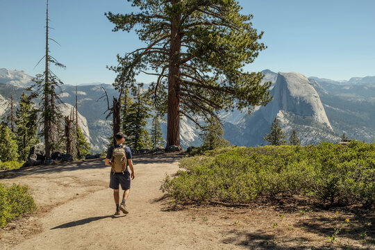 Hiker walking trail toward Half Dome in Yosemite