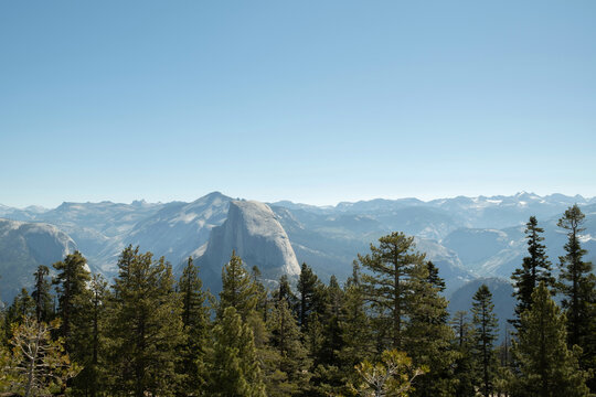 Half Dome granite peak view over Yosemite forest