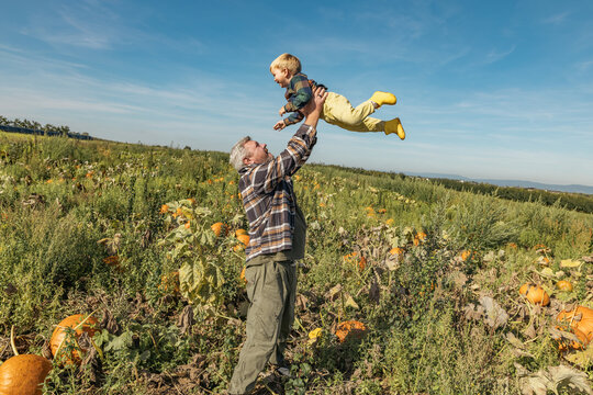 Family enjoying an autumn day in a pumpkin field