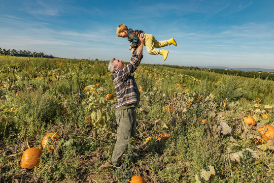 Family enjoying an autumn day in a pumpkin field