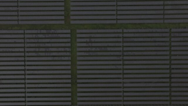 Aerial drone view of a solar power farm on Dau Tieng Lake, Tay Ninh, Vietnam, showcasing photovoltaic panels, renewable energy and sustainable technology across a vast lake landscape.
