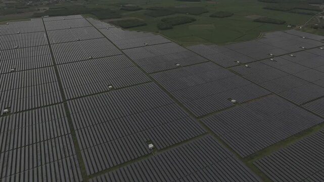 Aerial drone view of a solar power farm on Dau Tieng Lake, Tay Ninh, Vietnam, showcasing photovoltaic panels, renewable energy and sustainable technology across a vast lake landscape.