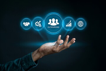 Obraz premium Professional holding virtual outsourcing hologram for global business growth and team management