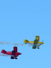 Red and Yellow Aerobatic Biplanes Flying at Pacific Airshow Gold Coast © blueringmedia
