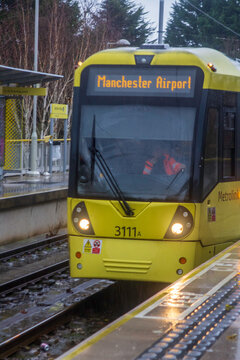 A Bee Network public tram arriving at Northern Moor stop in Greater Manchester England
