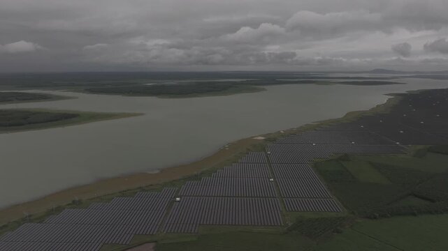 Aerial drone view of a solar power farm on Dau Tieng Lake, Tay Ninh, Vietnam, showcasing photovoltaic panels, renewable energy and sustainable technology across a vast lake landscape.