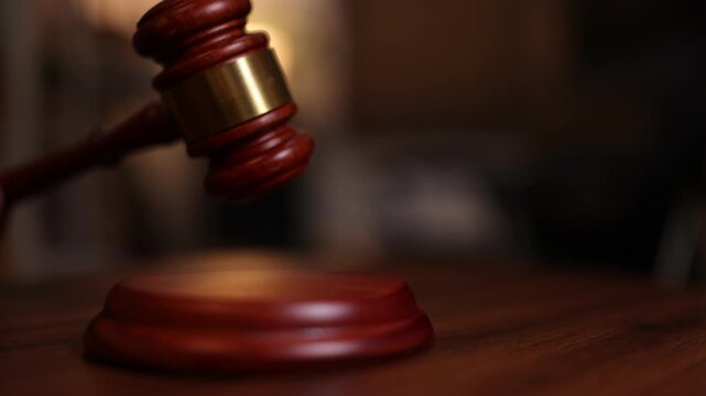 Justice hammer decision on a bench in a court room setting. 