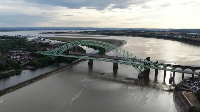 Aerial view of a train crossing the runcorn railway bridge
