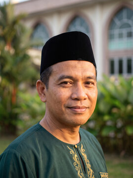 Malay Man Wearing Traditional Songkok and Baju Melayu