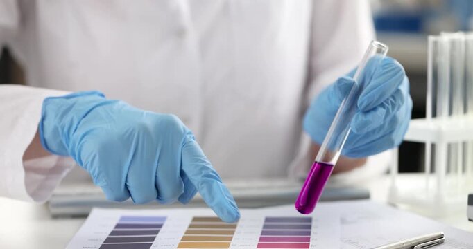 In a bright laboratory, a skilled scientist analyzes vibrant test tube colors. With careful precision, they compare results against colorful charts, showcasing scientific exploration.