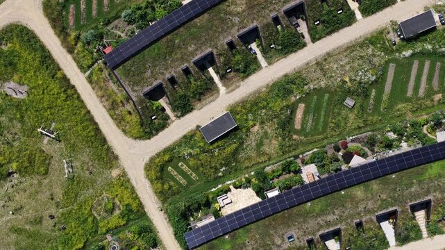 Earthship sustainable houses with green roofs and solar panels