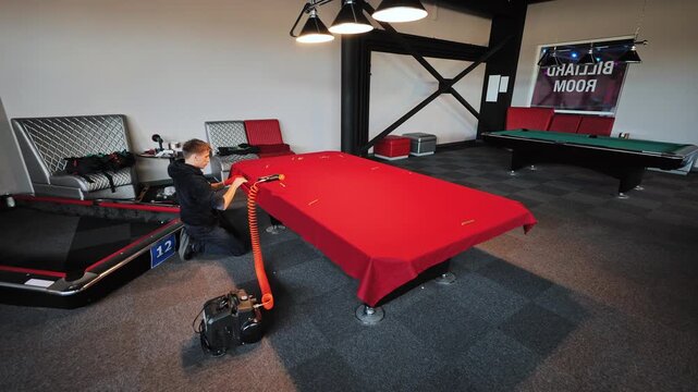 Precise stapling fixes stretched fabric firmly across restored billiard surface