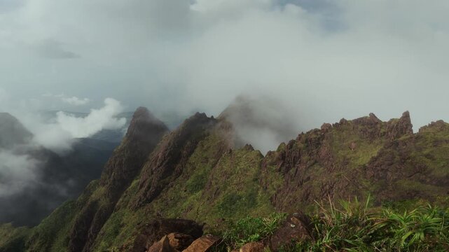 Jagged Mount Guiting-Guiting ridge emerges from clouds on Sibuyan Island, Philippines, static nature backdrop with nobody