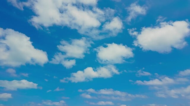 White Clouds Drift Across A Blue Sky Above The Okinawa Islands, Japan, With An Open Tropical Sky Scene. Low-angle shot