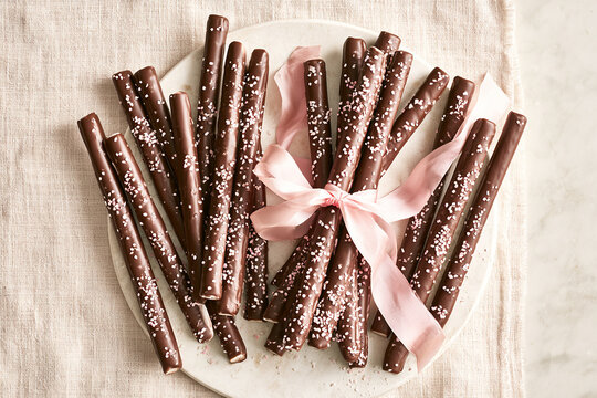 Chocolate Dipped Snack Sticks on Beige Linen Background