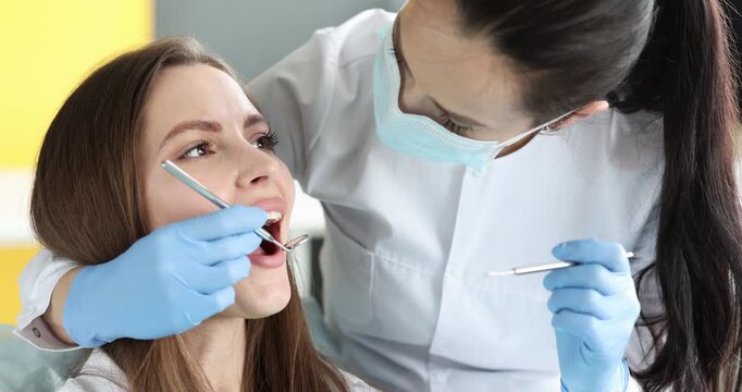 A skilled dentist checks a patient's teeth in a colorful clinic. The atmosphere is friendly, making the visit enjoyable and reassuring for everyone involved.