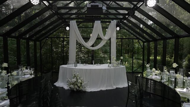 Glass pavilion wedding reception with draped swags and illuminated ceiling rig, with wedding, pavilion, glass, headtable detail, showing drapery, swag, linen, flower context