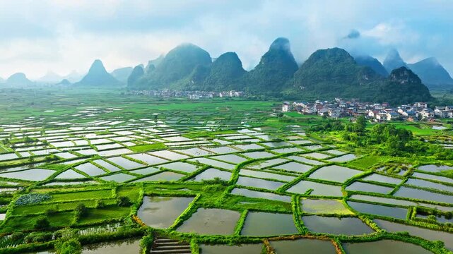 Aerial view of green karst mountains and rural flooded rice fields in Guilin, China