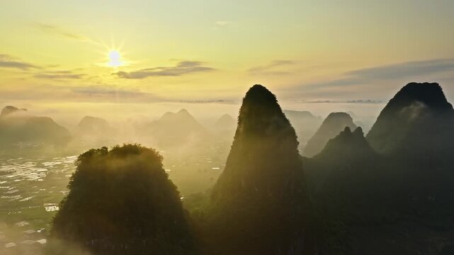 Aerial view of sunrise over misty karst mountain peaks in Guilin, China