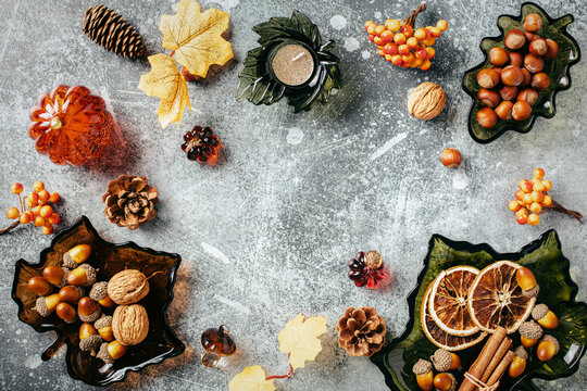Autumn harvest frame with leaf glass dishes on grey background