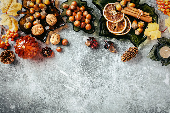 Autumn top border with leaf shaped glass bowls and dried fruits