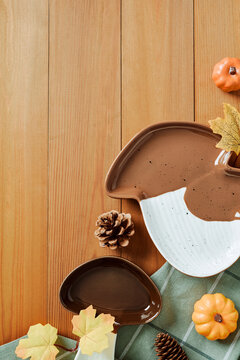 Autumn harvest decor with mushroom ceramics on wooden background