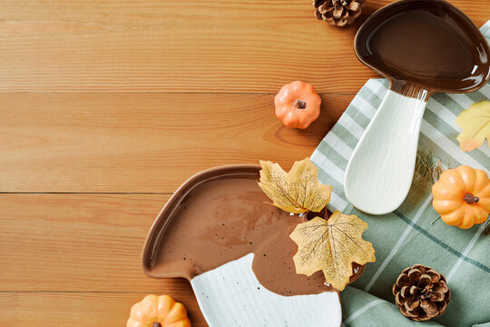 Autumn mushroom shaped ceramic dishes on wooden table