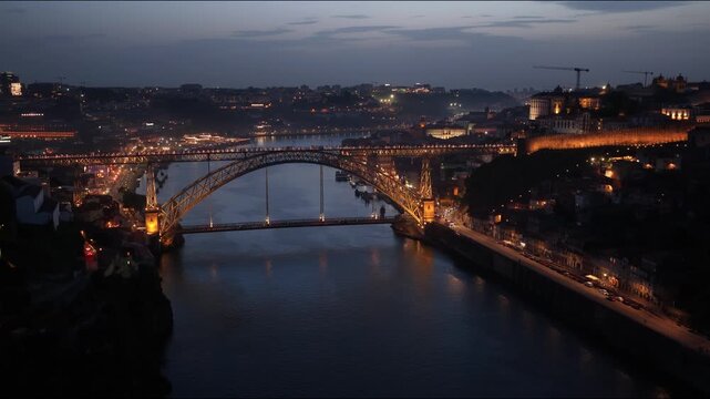 Dom Luis I Bridge illuminates over the Douro River in Porto at night