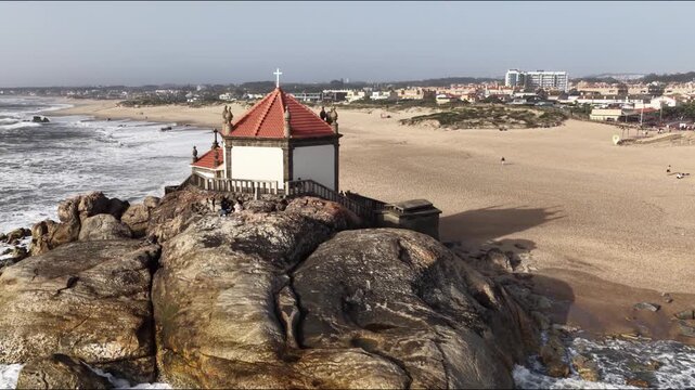Capela do Senhor da Pedra overlooking the Atlantic ocean beach in Porto Portugal