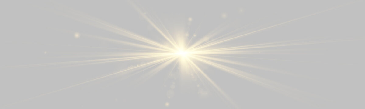 Gold light beams radiate outward against a black background in multiple directions. The luminous glow is accompanied by scattered glowing particles and soft bokeh effects that enhance the.