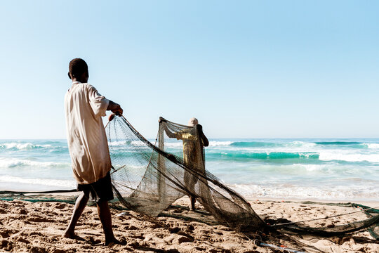 Rural fishermen with their fishing net on the beach