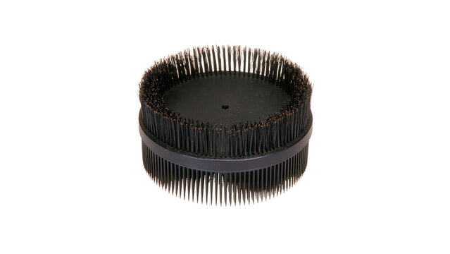 Round black plastic cleaning brush attachment with stiff bristles on transparent background