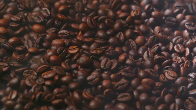 Cinematic dolly move across freshly roasted coffee beans releasing aromatic steam, highlighting rich texture, warmth and an irresistibly indulgent coffee experience.