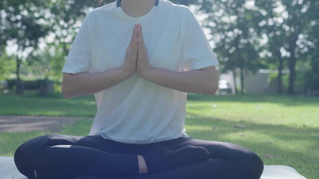 woman practicing meditate on the park. Asian woman doing exercises in morning. balance, recreation, relaxation, calm, good health, happy, relax, healthy lifestyle, reduce stress, peaceful, Attitude.