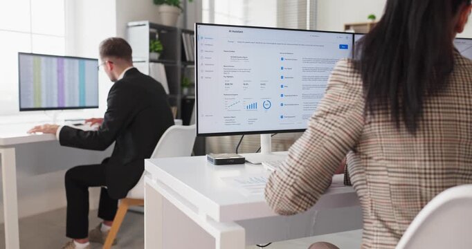 Business analysts colleagues in office conduct computer analysis. They review dashboards, assess metrics, and align strategy with manager to boost growth. Data driven teamwork and analytics.