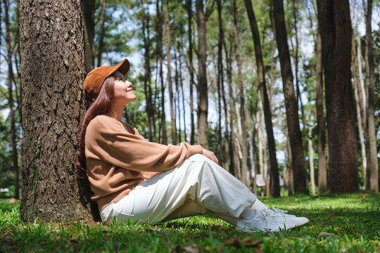 Portrait image of a woman sitting and relaxing in the park