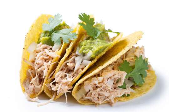 Carnitas tacos with guacamole, cilantro, onion and lime isolated on white background