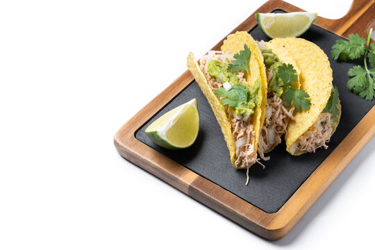 Carnitas tacos with guacamole, cilantro, onion and lime isolated on white background. Copy space